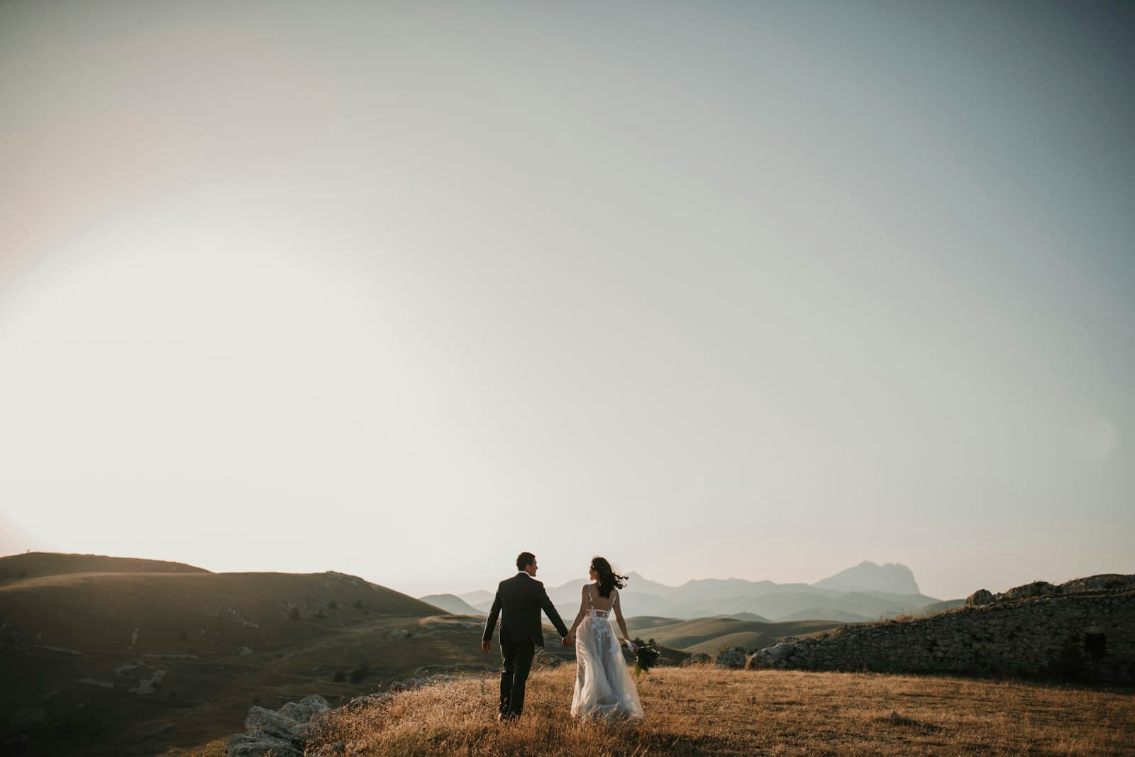 The couple embracing at sunset